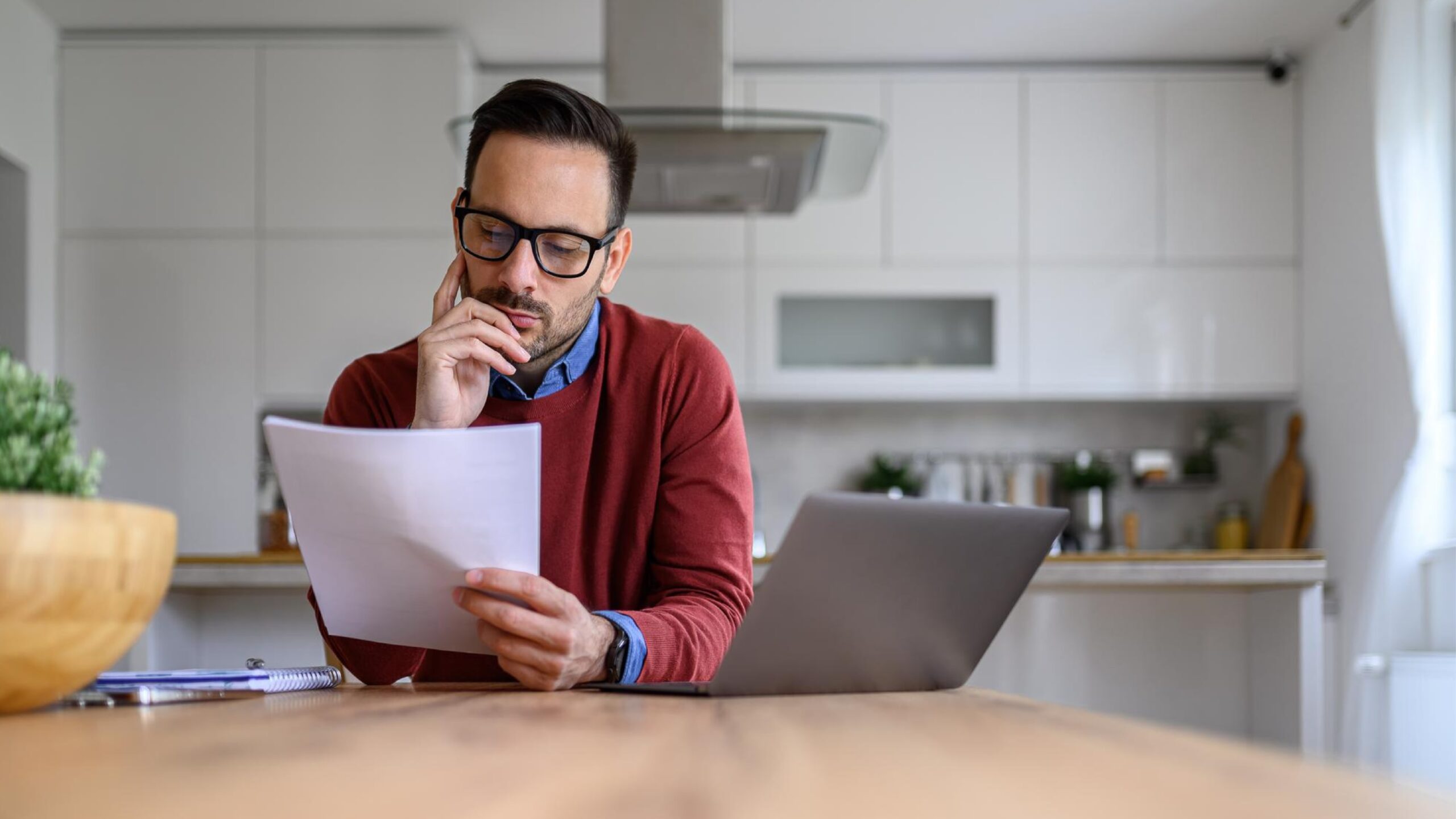 A person looking at bills thinking about how to improve telecom cost management across their sites.